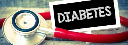 Diabetes als Schriftzug auf Tafel neben Stethoskop